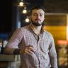 portrait-man-with-hand-his-pocket-holding-glass-drink_23-2147861968